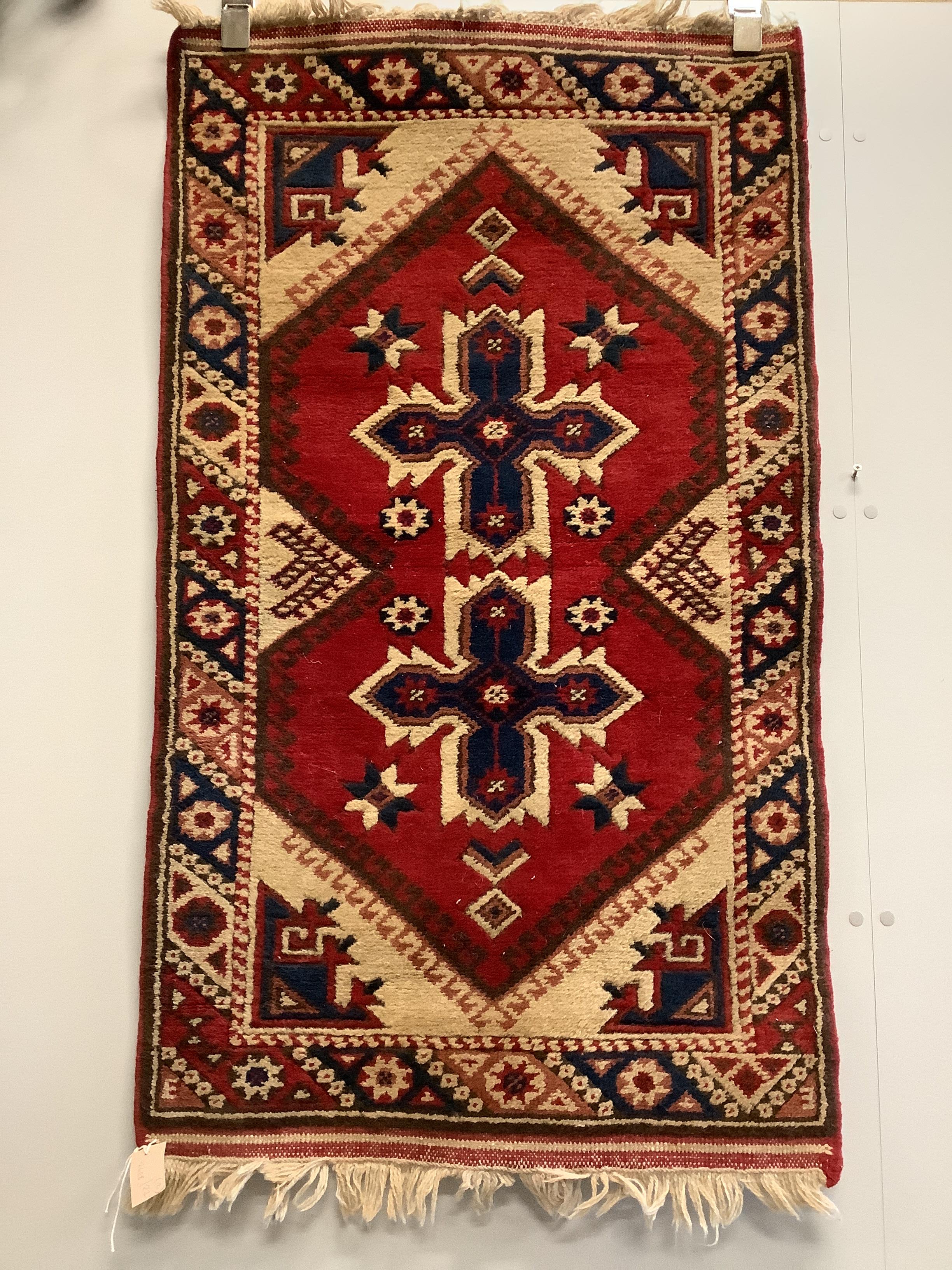 A Caucasian style red ground rug together with a North West Persian blue ground rug, larger 124 x 73cm